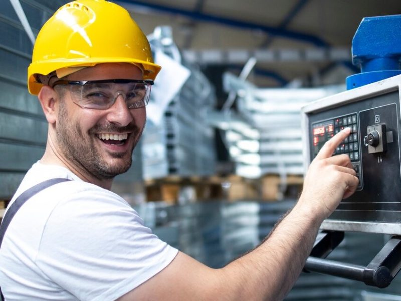 portrait-factory-worker-operating-industrial-machine-setting-parameters-computer_342744-139
